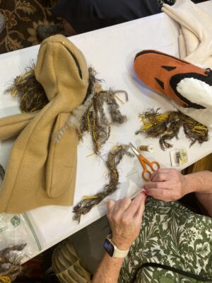 A Cordia at Grand Traverse Commons Member works on a puppet